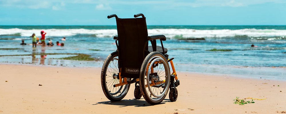 How Thoughtful Planning Makes Accessible Travel Smooth and Successful - The Wise Traveller - Wheelchair on beach