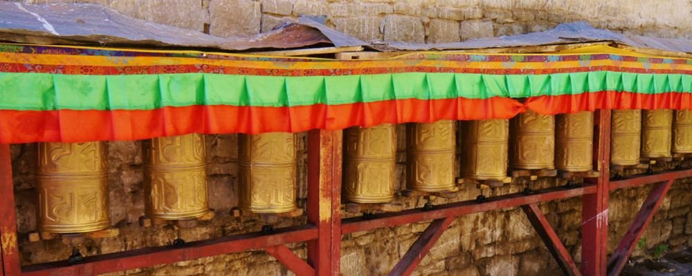 My Journey with His Holiness the Dalai Lama - The Wise Traveller - Stationary Prayer Wheels at the Base of the Potala