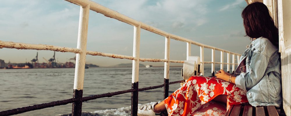 Plotting for a Solo Adventure - The Wise Traveller - Woman sitting by herself
