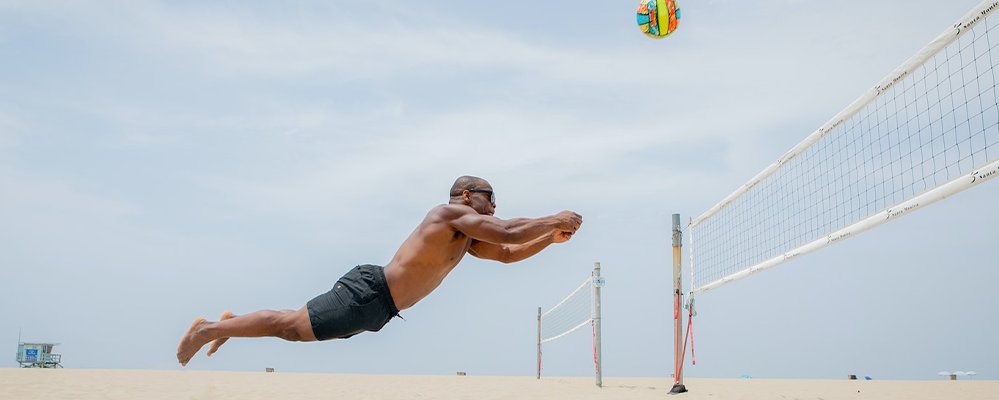 The Benefits of Staying Active While on Vacation - The Wise Traveller - Beach Volleyball