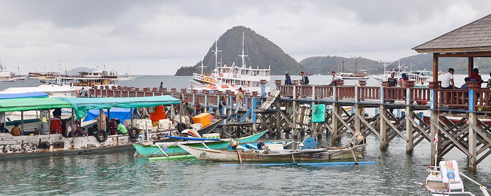 The Next Tourist Hotspot - Flores - Indonesia - The Wise Traveller - White Boats and people